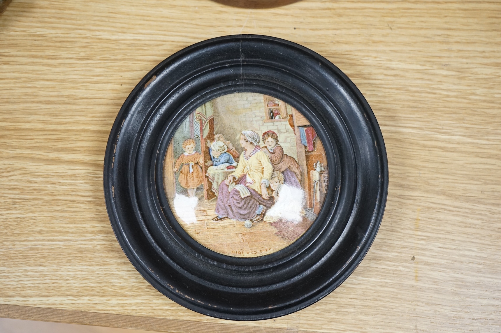 A Duke of Wellington pot lid, another Prattware pot lid and a German floral encrusted porcelain mirror, largest 33cm high